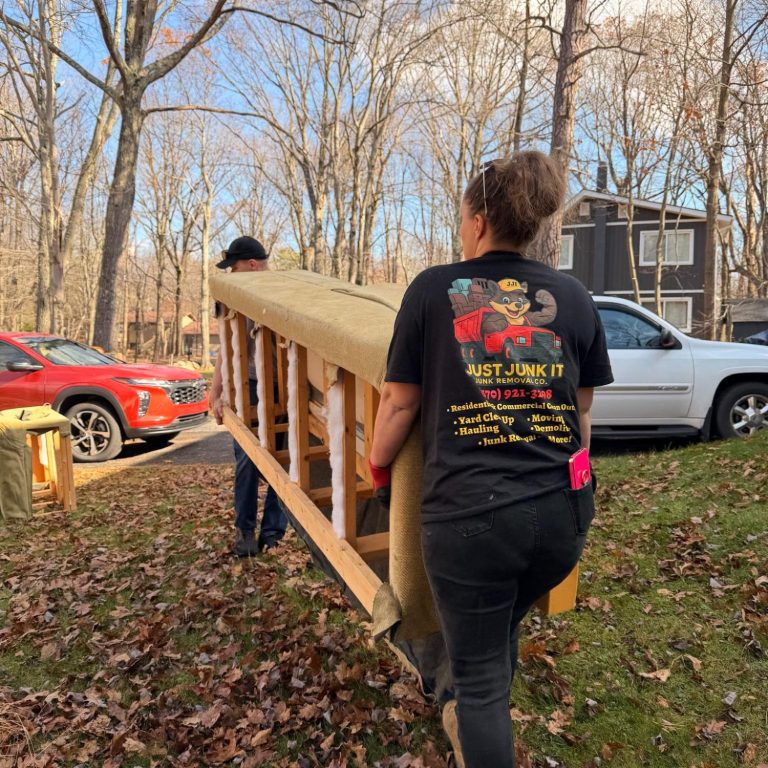 Just Junk It team safely removing and moving furniture during a junk removal project